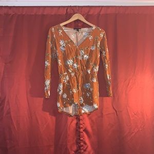 Forever 21 orange romper with floral accents.